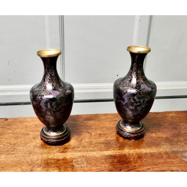A Pair of Black Cloisonné Baluster Vases on stands A very unusual pair of French cloisonné baluster vases, the vases are...