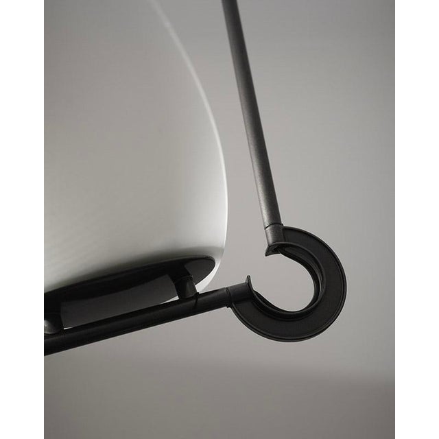 The "tebe" chandelier was designed by ernesto gismondi and sergio fassina for artemide in the 1980s. The lamp features a...