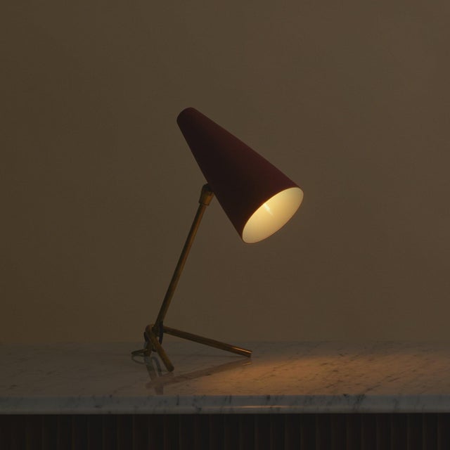 A petite Italian table lamp by Stilux, dating to the 1950s. This compact design features a slender brass frame with a warm...