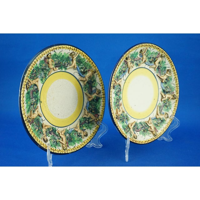 Item description: a rare pair of glazed and vitrified ceramic plates, entirely handmade, with a white base and a yellow...