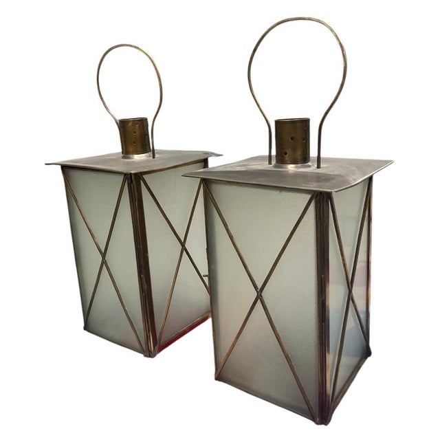 A striking and elegant pair of large-scale hurricane lanterns, beautifully crafted in a timeless Neoclassical design....