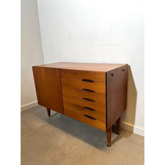 Beautiful vintage mid-century modern sideboard in warm teak veneer, featuring a clean architectural design with elegant...