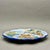 This mid-century hand-painted Spanish Talavera ceramic plate features a beautifully fluid scene of a leaping stag...