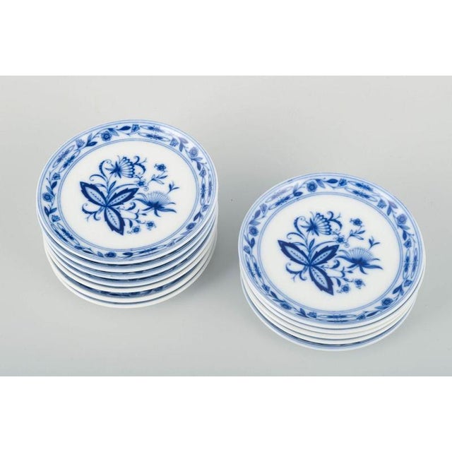 J. Kronester, 12 butter/side plates. Set of 12 small plates from j. Kronester, decorated in underglaze blue with the...
