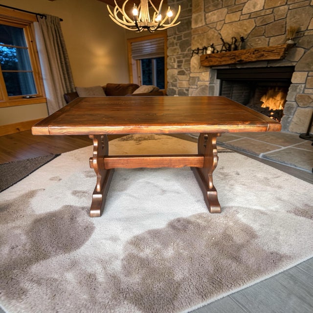 Gorgeous example of a solid wood trestle base table hand made and hand rubbed finish by Drake and Smith furniture builders...