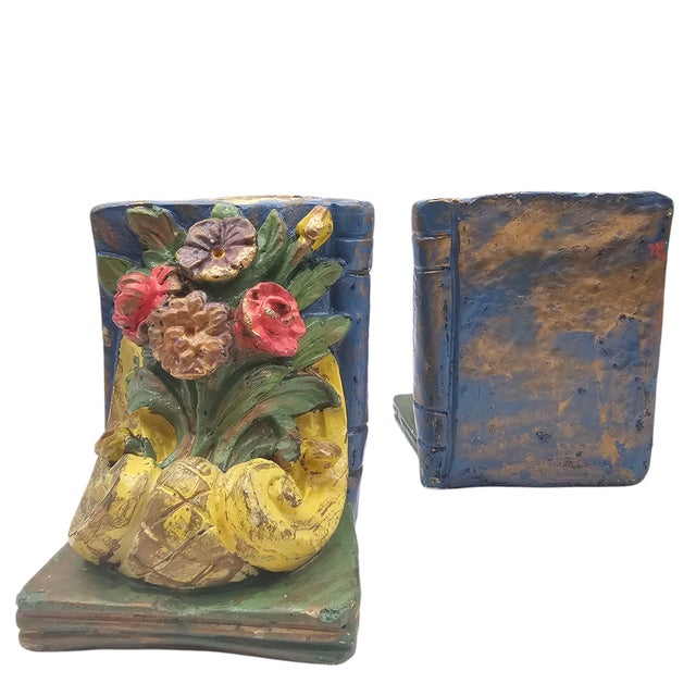 This pair of chalkware bookends reflects early-twentieth-century molded plaster production associated with baroque-...