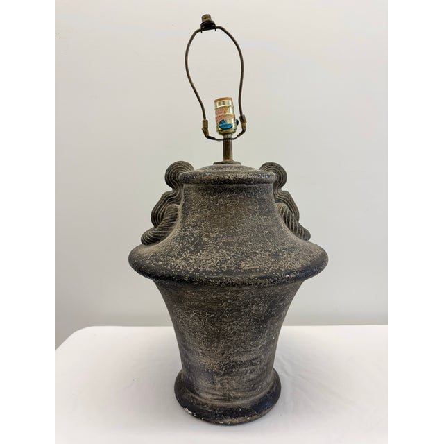 A substantial 1987 ceramic table lamp by Bon Art featuring a sculptural urn silhouette inspired by traditional...