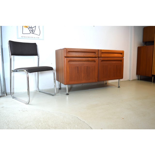 This is a high-quality teak sideboard from the Danish manufacturer Kollund Möbler. The cabinet was made in the 1970s. A...