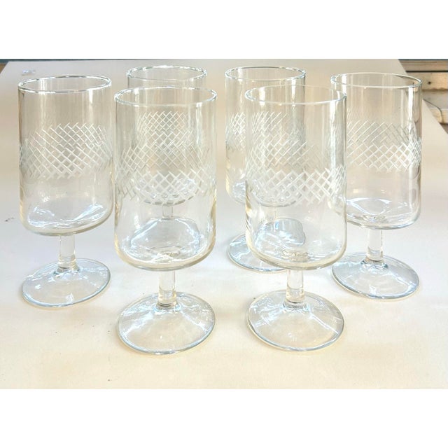 Set of 6 mid-century etched stemmed water or wine goblets featuring a crisp criss-cross band design wrapping the center of...