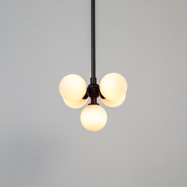 Five glowing orbs float in balance - a radiant cluster of glass and charm. Minimal, magical, and just the right amount of...