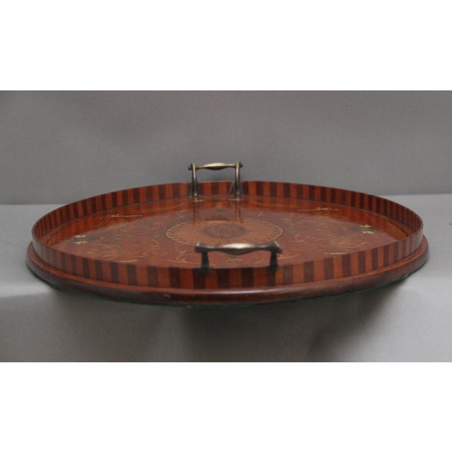 A highly decorative 19th Century inlaid satinwood tray of oval form, having a raised gallery with brass carrying handles...