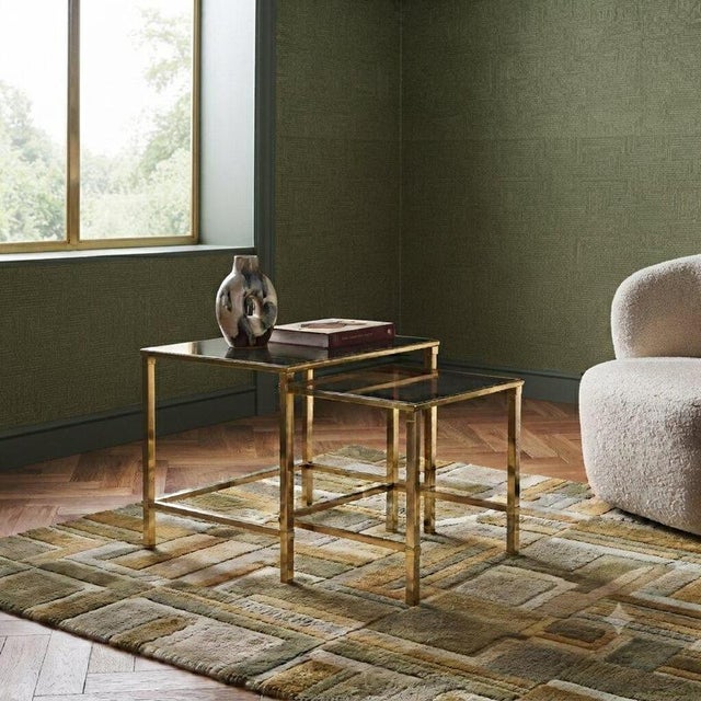 Nesting tables in brass from the 1960s-70s, characterized by a sleek and functional design that integrates perfectly into...