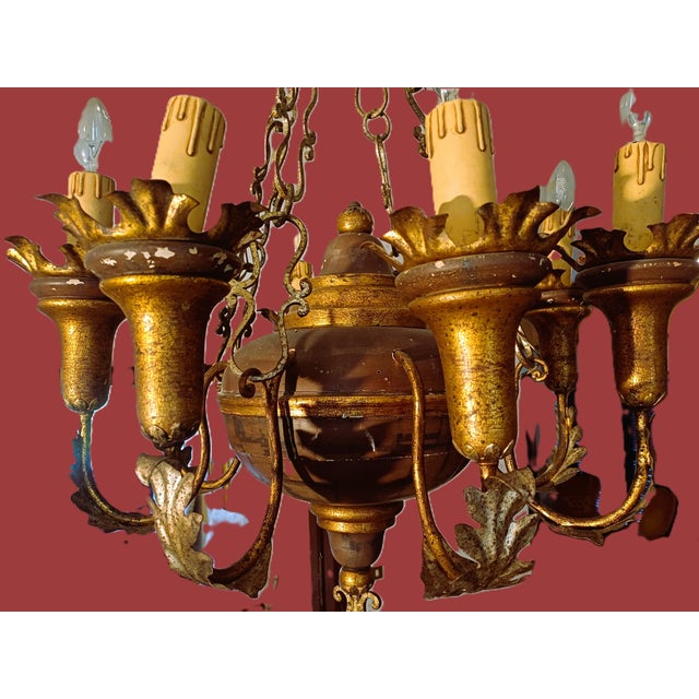 A pair of important six-branched chandeliers in wood and brass. Style: Eclectic Art Nouveau; Period: 1920-30 There is a...