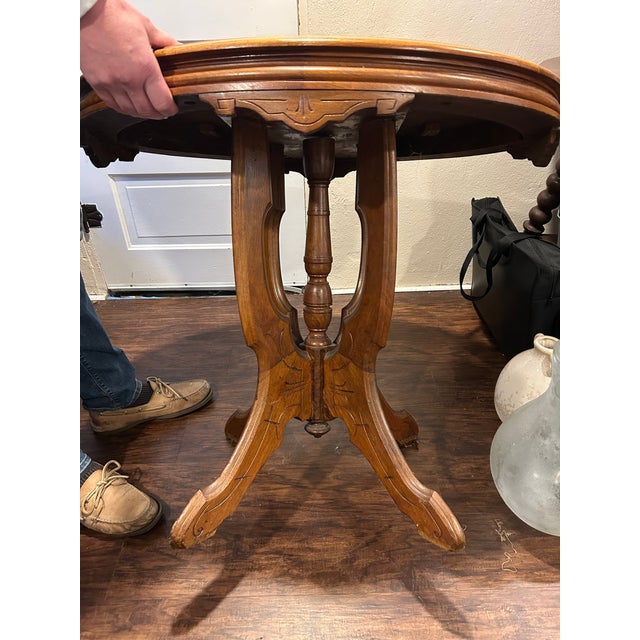 Carved walnut parlor table in the Eastlake style. Likely from late 1800s. No makers markings. Some scratches on surface...