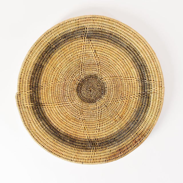 Handwoven Makenge flat wedding basket handmade by the Mbundu women within Zambia. These baskets are traditionally made...
