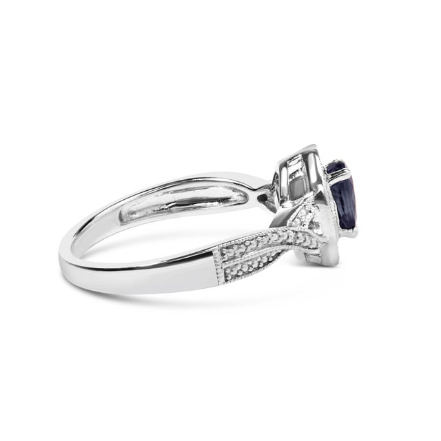 Indulge in the exquisite allure of this .925 Sterling Silver Sapphire and Diamond Halo Fashion Band Ring. Crafted with...
