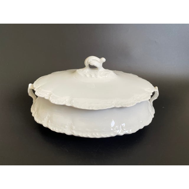 An antique oval covered serving dish in the Hudson All White pattern by Homer Laughlin. This elegant piece features...
