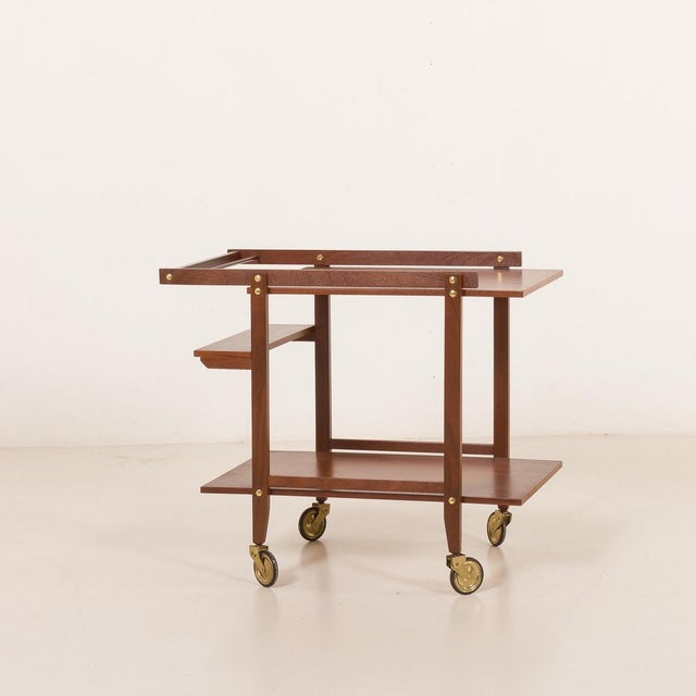 An elegant scandinavian mid-century bar cart crafted in teak comes from the 1960s. overall cart size is h: 68 / w: 80 / d:...