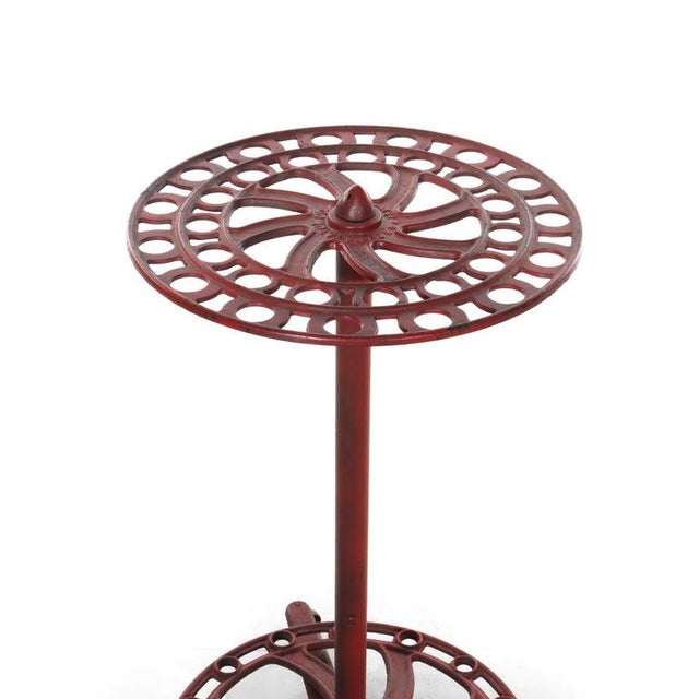 An antique country store broom display rack, manufactured by S. C. Tatum Co. around 1885. Crafted from a robust cast iron...
