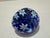 Small vintage egg-form art glass paperweight with cobalt blue ground, white and green millefiori canes, and applied gold...