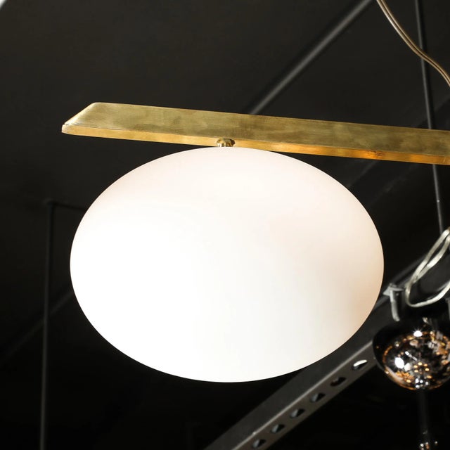 This stunning Modernist Asymmetrical Brushed Brass & Frosted Glass Four-Arm Globe Chandelier in the Manner of Arredoluce...