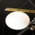 This stunning Modernist Asymmetrical Brushed Brass & Frosted Glass Four-Arm Globe Chandelier in the Manner of Arredoluce...