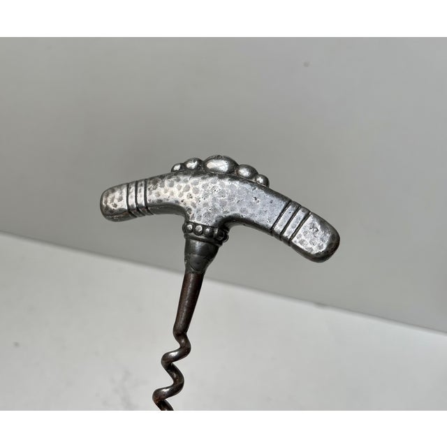 In the style of Thorvald Bindesbøl comes this stylish jugendstil corkscrew with handle in hammered pewter. It was made in...