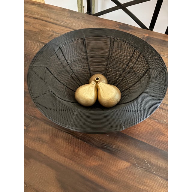 This striking large-scale decorative bowl features a dense, horizontal wire-work construction with a dramatic wide, flat...