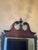 Wall mirror in the Georgian / Chippendale taste: a broken swan-neck pediment centred on a turned urn finial, pierced and...
