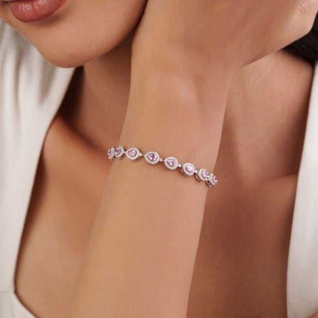 This elegant tennis bracelet features 2.74 carats of pink sapphires, set in 14k white gold. Each sapphire measuring 4 x 3...