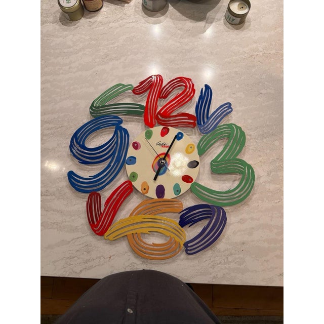 David Gerstein Art Time Laser Cut Metal Decorative Wall Clock. This vibrant, multi-layered metal wall clock features a...