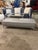 This sophisticated Roche Bobois bench features a sleek, elongated silhouette upholstered in smooth gray leather, elevated...
