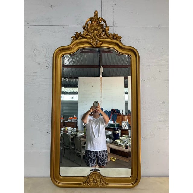 large scale antique louis Philippe carved and giltwood mirror from France. Featuring an arched top and pretty carved...