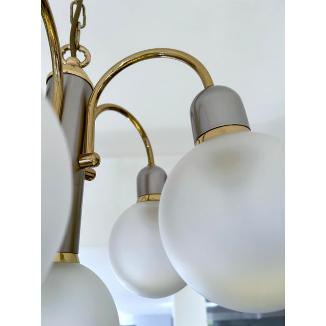 Vintage mid century century cascade style pendant light, brass and gunmetal color structure with curved spokes and frosted...
