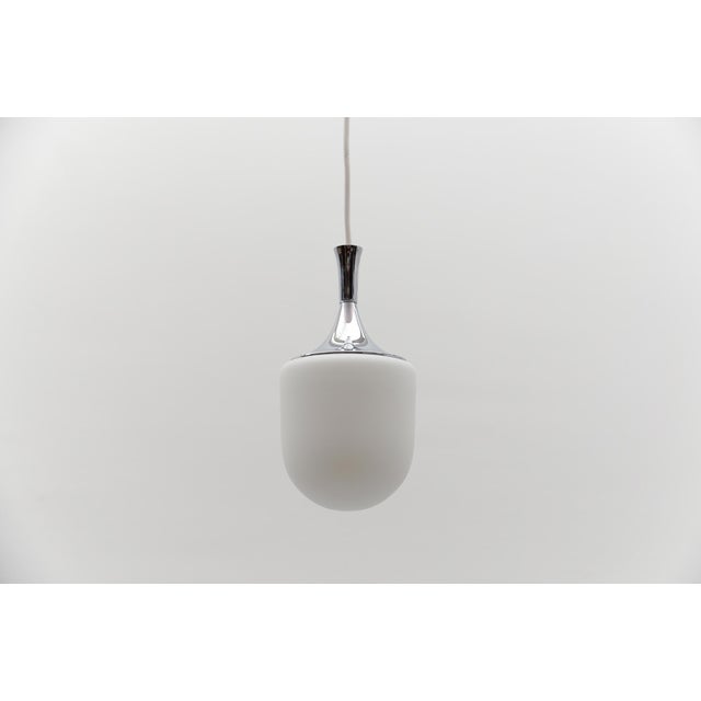 Petit Space Age Opal Glass Hanging Lamp with Chrome, 1960s Germany Executed in opaline glas and Chrome. The lamp can be...