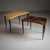 Two coffee tables by Aldo Tura featuring trapezoidal tops covered in goatskin parchment. The tables rest on ebonized...