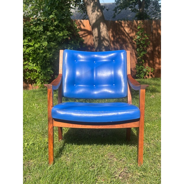 Striking mid-century modern lounge chair by Gunlocke, featuring a sculpted solid walnut frame paired with bold original...