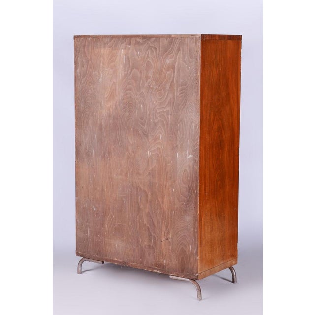Original walnut wardrobe made in Czechia by Robert Slezak Period: 1930-1939 Condition: Original Material: Walnut and...
