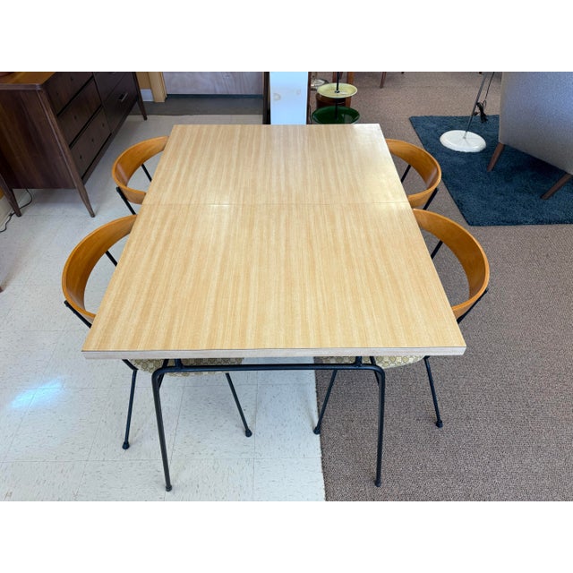 Great looking 1950’s dinette table and 4 chairs by Clifford Pascoe. The iron framed table features a blonde woodgrain...