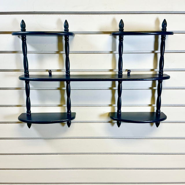 These were so popular in the Mid-Century. A wood multi-Tiered wall-mounted shelf unit to display collectibles. We’ve...