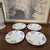 A charming set of four vintage Spode Copeland China plates crafted in England and decorated with colorful birds perched...