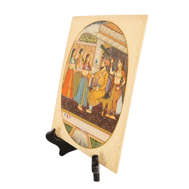 A fine antique Indian Mughal Miniature painting, in a carved camel bone frame. Circa 1900. The painting of oval outline is...