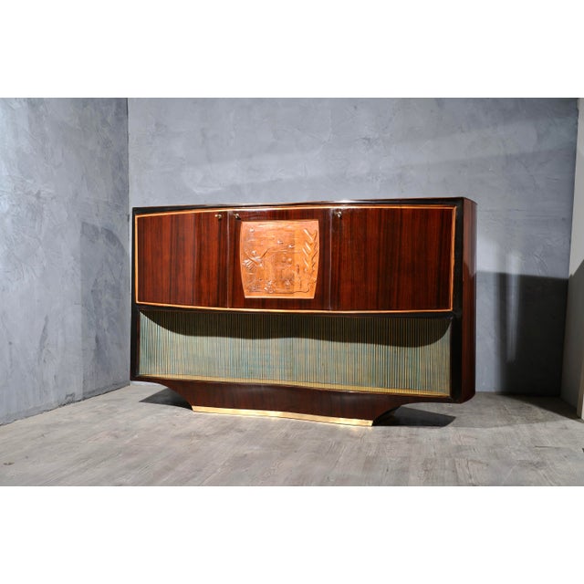 Bar cabinet buffet by Vittorio Dassi, composed of precious materials, such as walnut wood, brass and glass. All veneered...