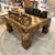 A spectacular European mid-century carved chess board coffee table with 32 carved wooden pieces. The legs of the table...