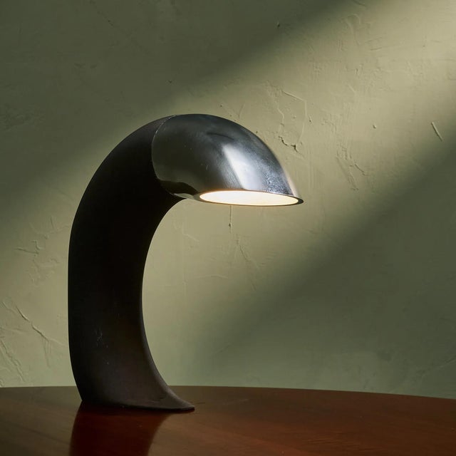 Highly sculptural table lamp by Fratelli Martini, Italy, circa 1975. The design is a circular shaped black lacquered steel...