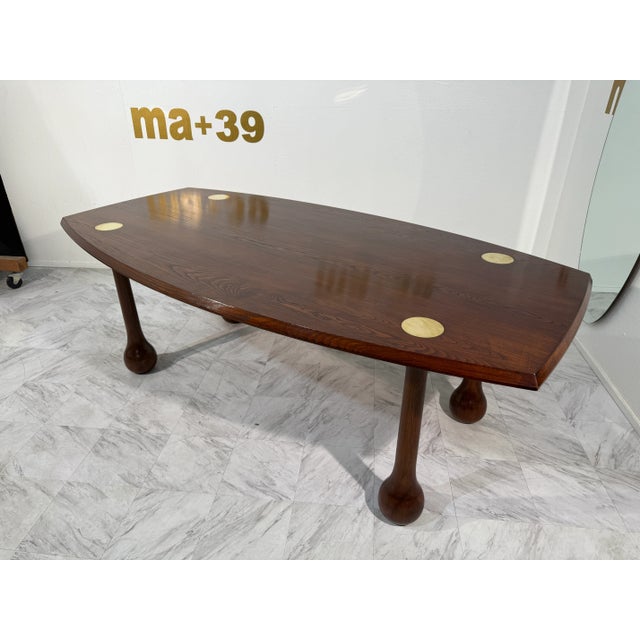 A sculptural Italian Mid-Century Modern dining table, distinguished by its organic form and bold craftsmanship. The table...