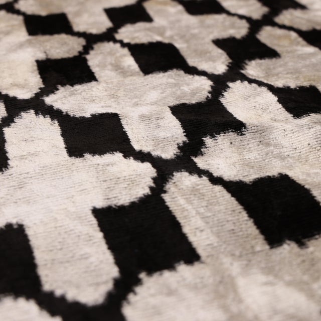 "Bold, graphic, and timeless, this handmade Ikat lumbar pillow is designed to make a refined statement. The pattern...