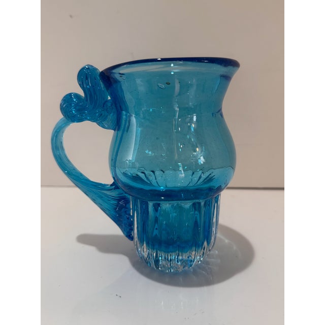 A delightful Murano-style hand-blown glass pitcher in a luminous aqua blue-green. Measuring 5.5” tall, this small pitcher...