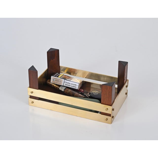 Gorgeous vide poche in walnut wood and solid brass. This elegant item was designed by Tommaso Barbi in Italy in the 1970s....