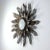 This Mid-Century sunburst sconce was produced in Spain in the 1950s. It is made of bronzed metal and has got a round opal...